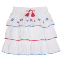 tween girls tiered mini skirt with blue and pink embroidery and pink and blue pom pom trim
