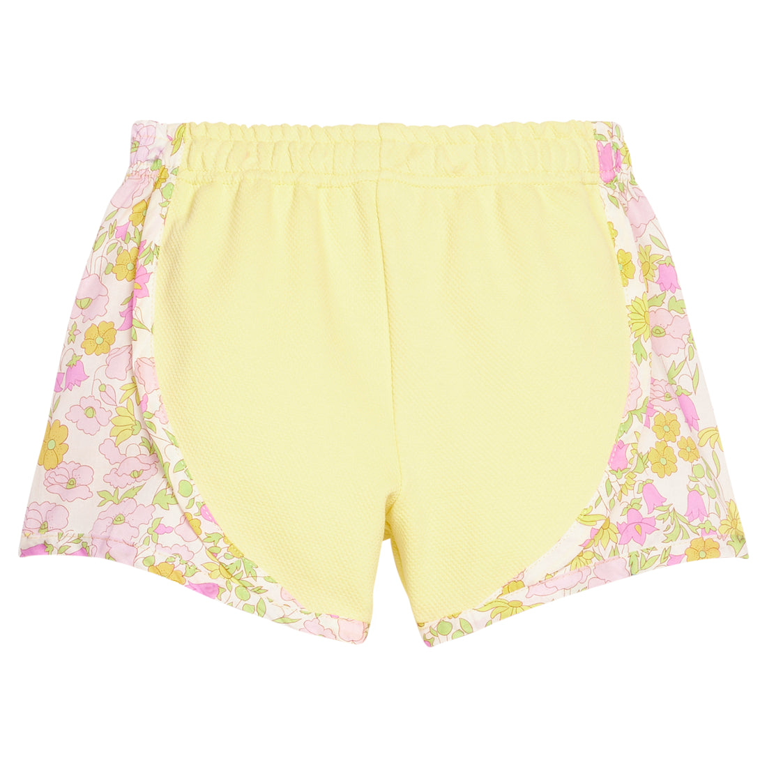BISBY girl knit yellow track shorts with woven yellow and pink floral print detail along sides of shorts. Shorts feature an elastic waistband as well for a secure but relaxed fit. 