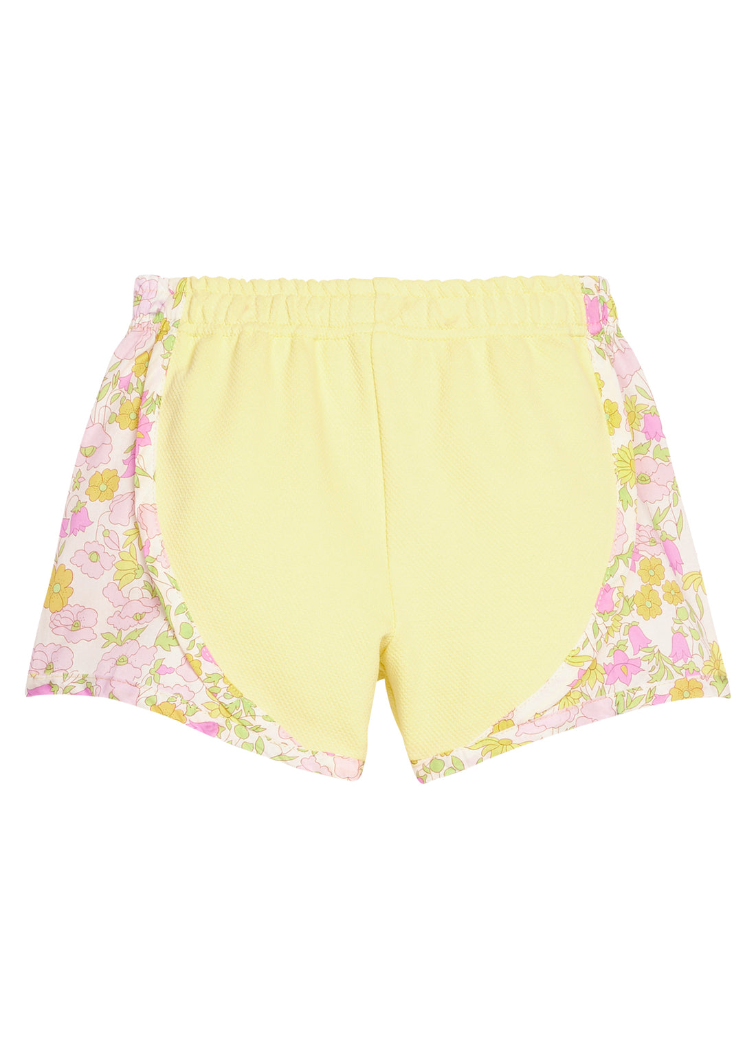 BISBY girl knit yellow track shorts with woven yellow and pink floral print detail along sides of shorts. Shorts feature an elastic waistband as well for a secure but relaxed fit.