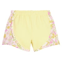 BISBY girl knit yellow track shorts with woven yellow and pink floral print detail along sides of shorts. Shorts feature an elastic waistband as well for a secure but relaxed fit.