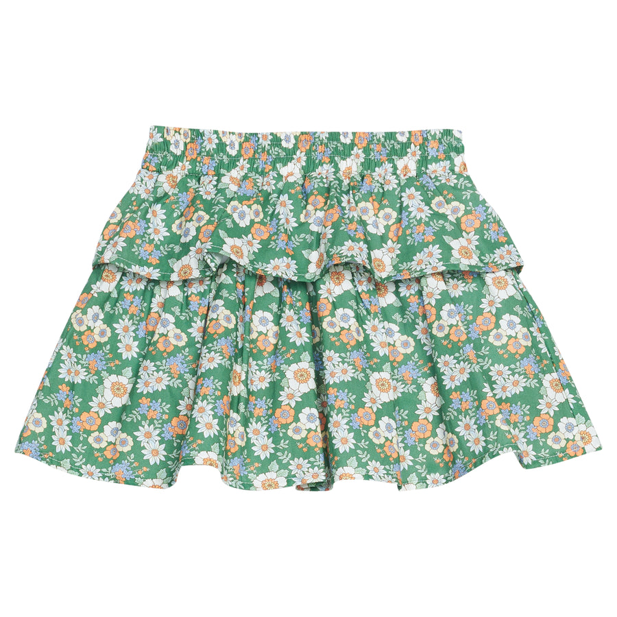 Girls woven skort featuring a green background with white, orange, and blue florals. 