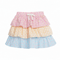Tiered skort with built in shorts and elastic waistband with faux tie. Top tier  of skirt has pink daisy pattern, middle tier has orange daisy pattern, and bottom tier has light blue daisy pattern.