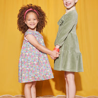 Little Girls seen wearing our Charlotte Dress in Merion Floral (left) and our Western Dress in sage Green (on right)--BISBY girls