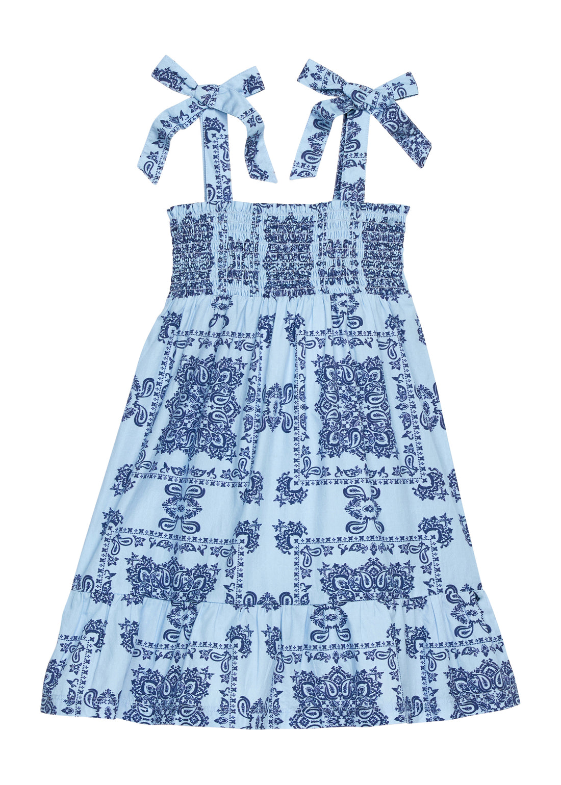 BISBY girl woven dress in a light blue/navy blue bandana print. Dress features wide straps with faux bow tie feature, smocking across bust, and bottom tier feature for an elevated look.