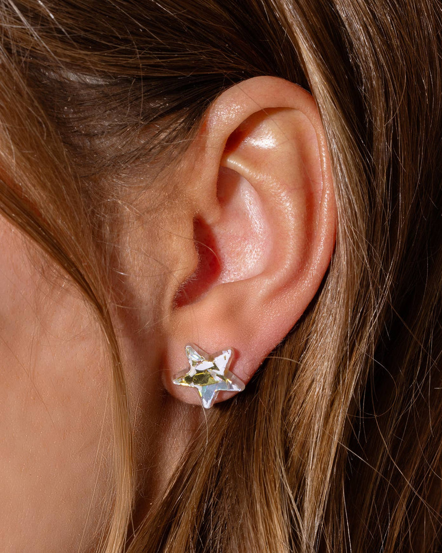 A girl wearing star shaped earrings