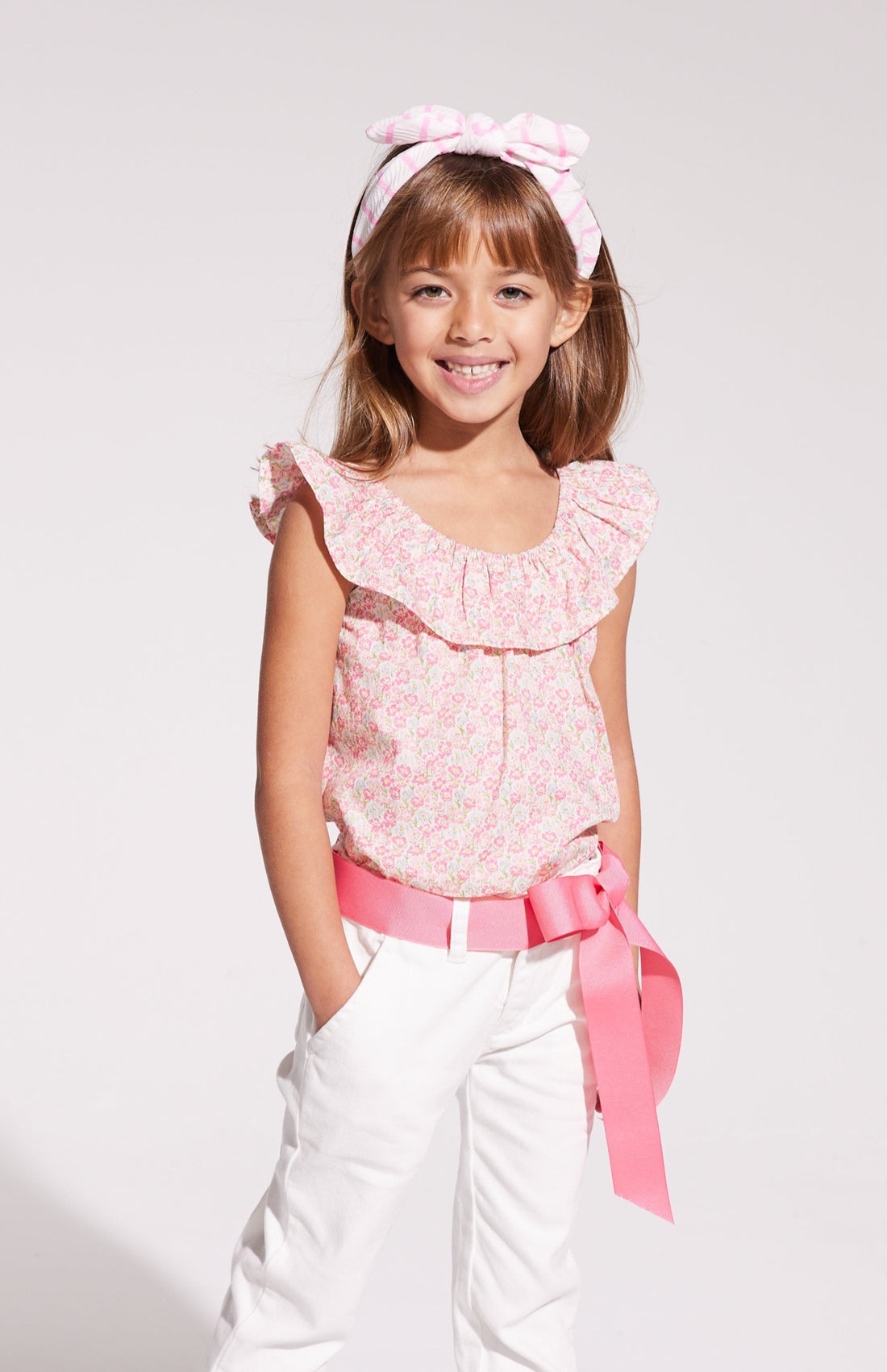 Pink floral sleeveless ruffle blouse with white jeans for girls and tweens