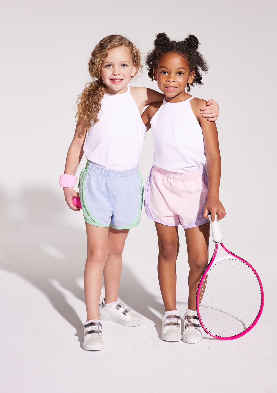 BISBY girls in our White Halter Top which pairs back perfectly with our track shorts!