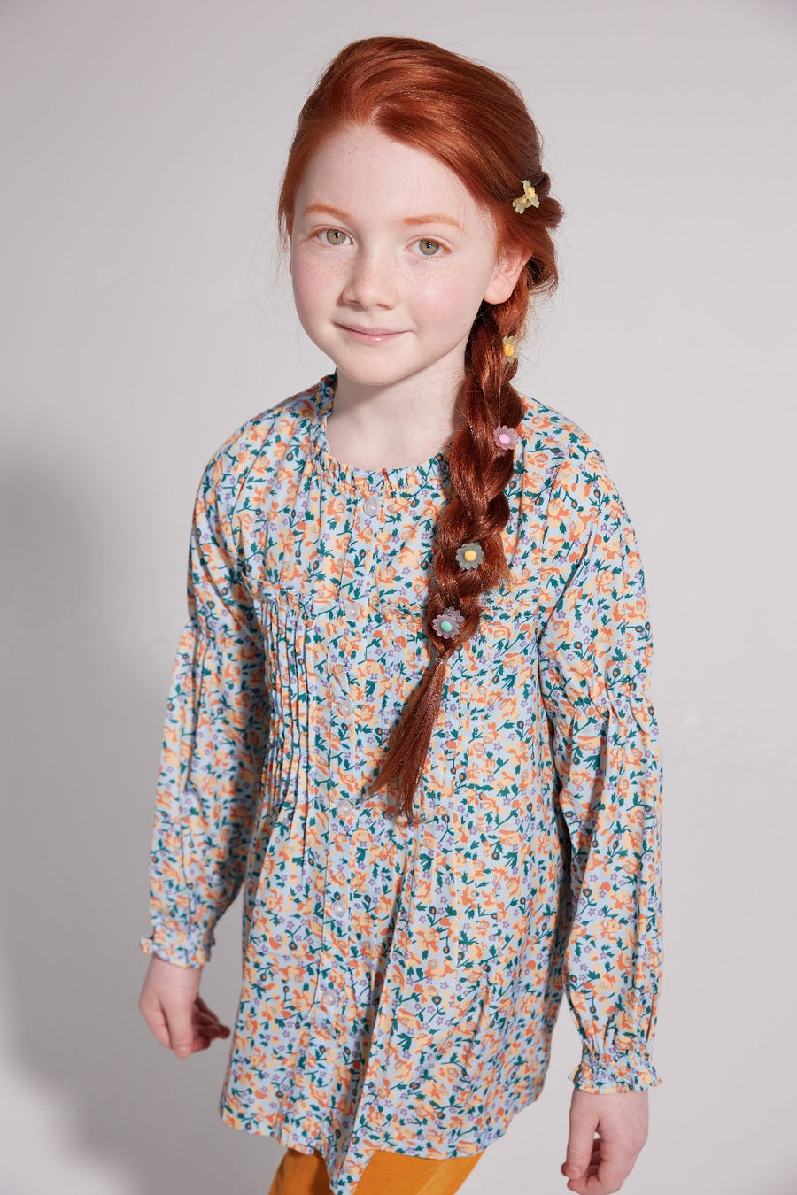 girls tween clothing flowy floral blue and yellow blouse with pleats on chest and ruffles at collar