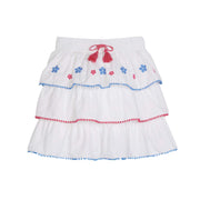 tween girls tiered mini skirt with blue and pink embroidery and pink and blue pom pom trim