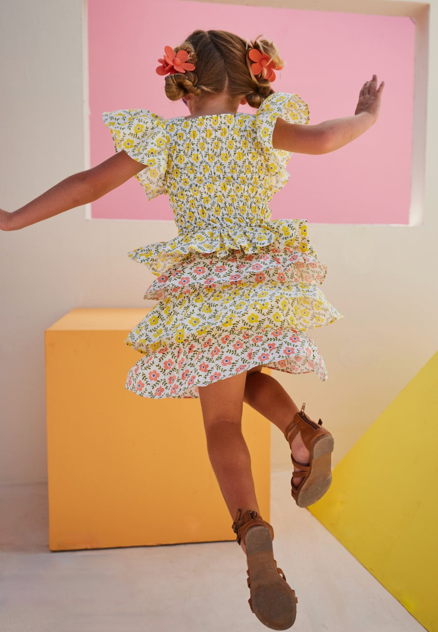 tween girls cinched top with flutter sleeves and peplum hem in yellow floral pattern