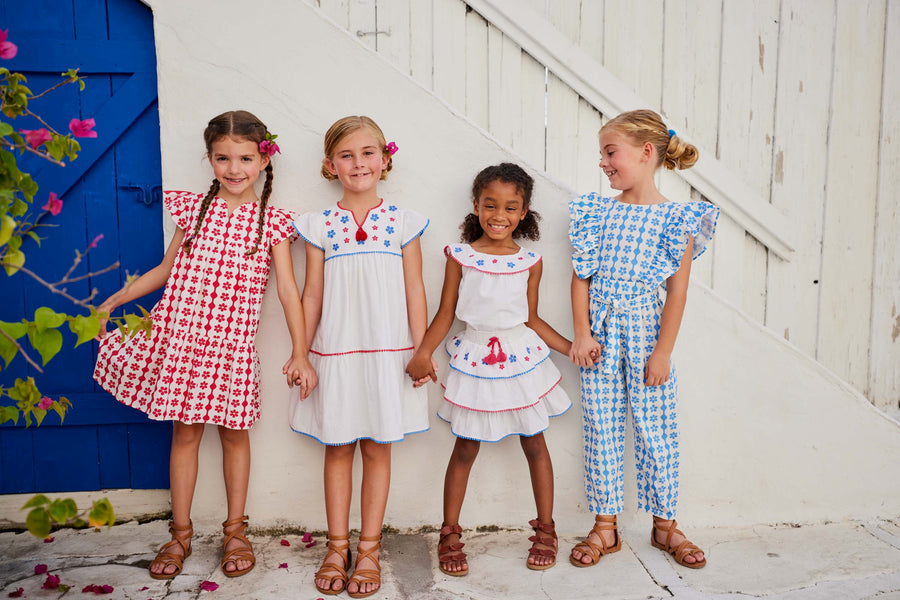 tween girls white tiered dress with blue and red embroidery detail on chest and tassels 