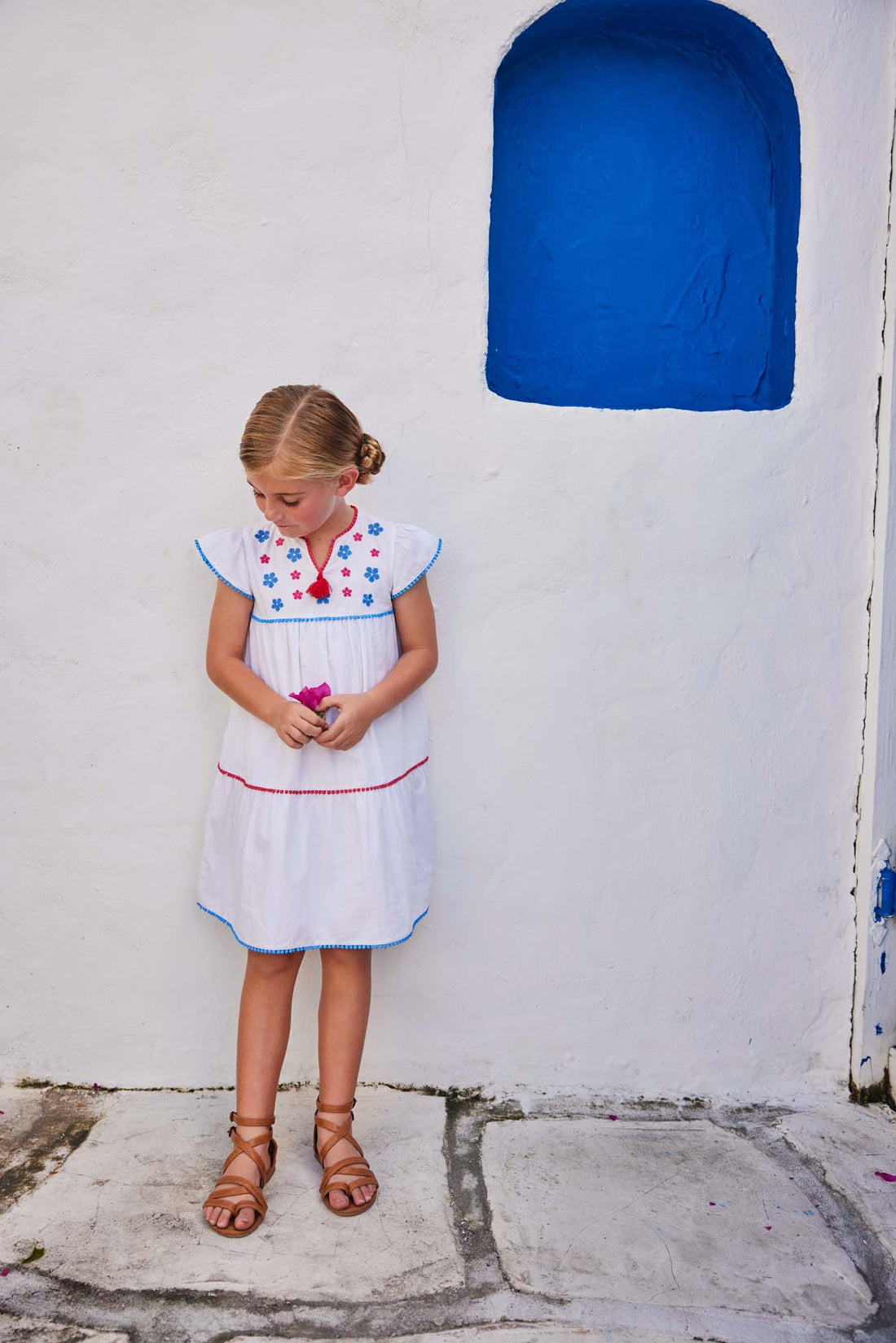 tween girls white tiered dress with blue and red embroidery detail on chest and tassels 