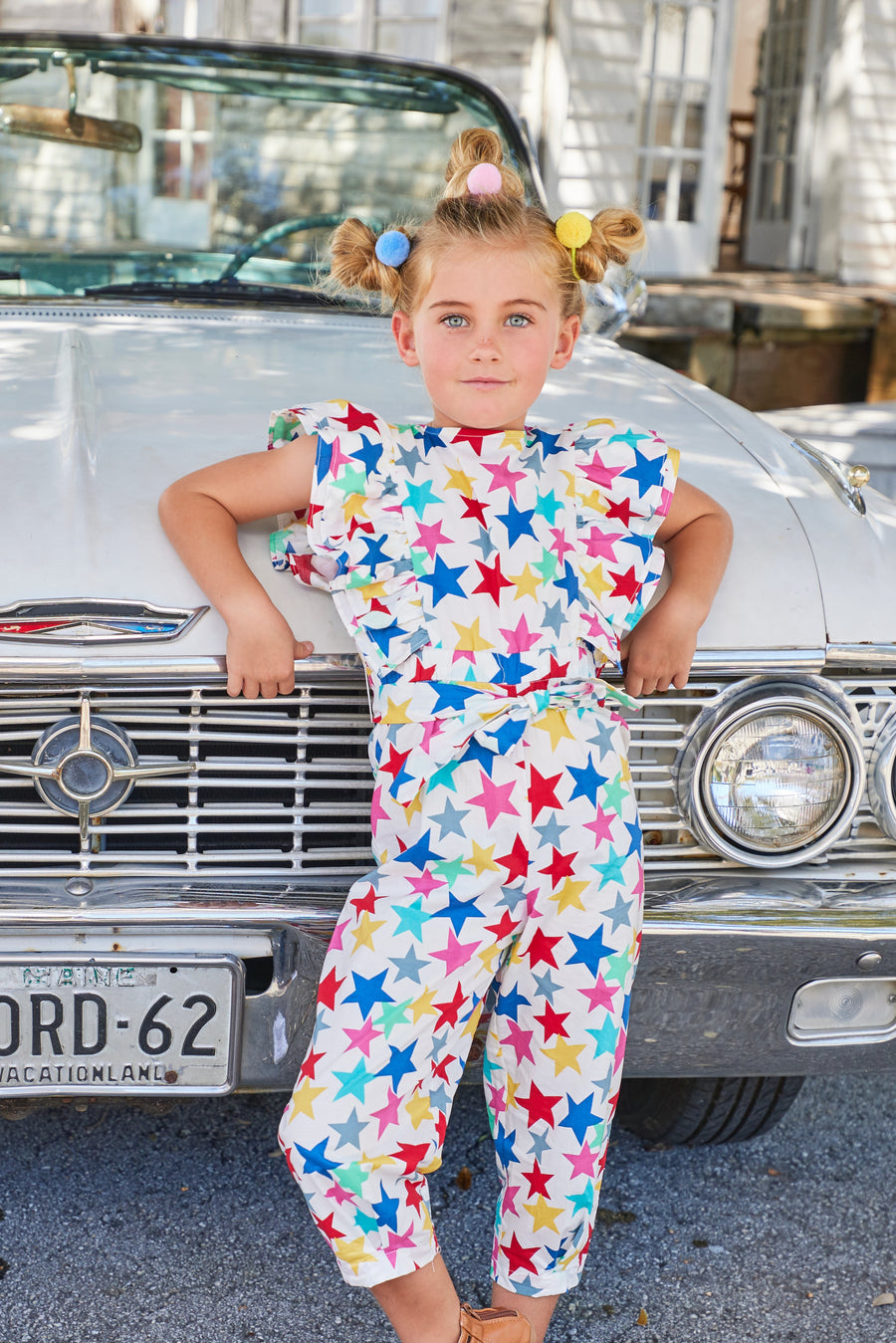 tween girls jumpsuit in multi-colored star pattern with ruffles and front tie 