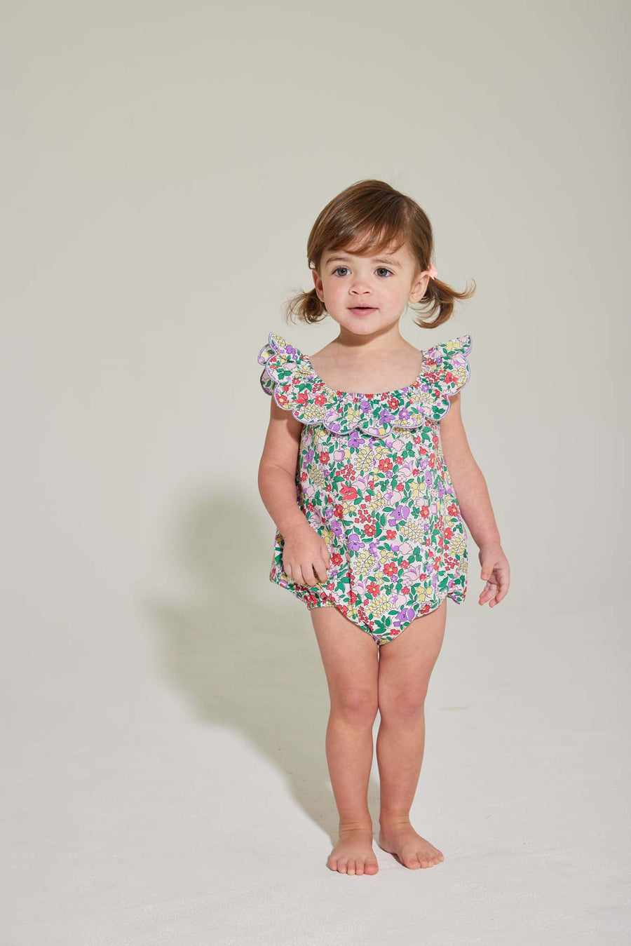 baby girl romper with scalloped neckline in purple floral pattern