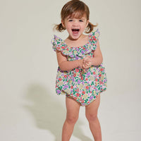 baby girl romper with scalloped neckline in purple floral pattern