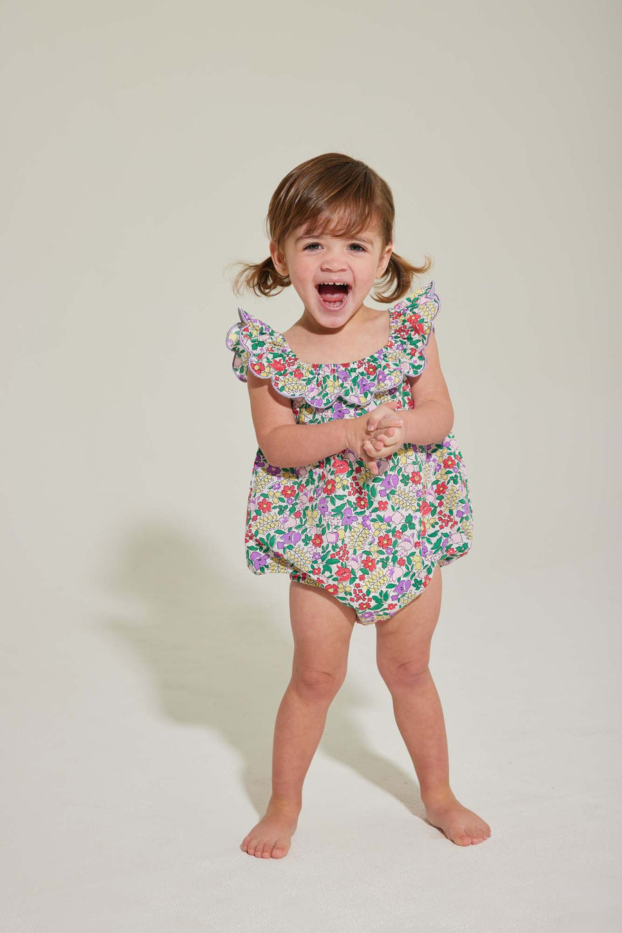 baby girl romper with scalloped neckline in purple floral pattern